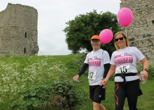 two participants walking hand in hand in the 'Havens to Havens Walk' event