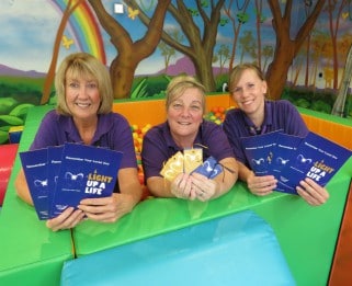 Little Havens care team holding Light Up A Life leaflets