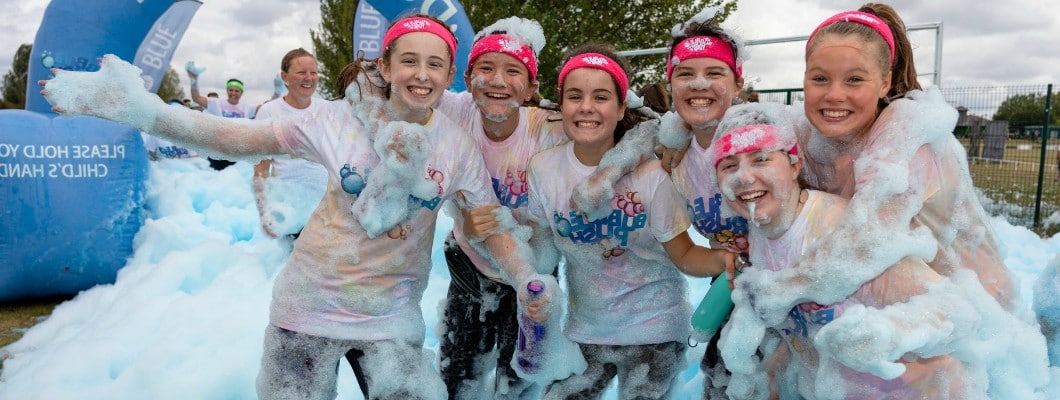 Children taking part in an event smiling