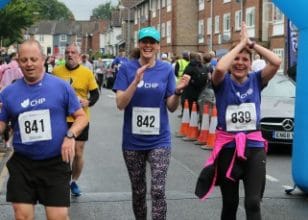 Three runners crossing finish line