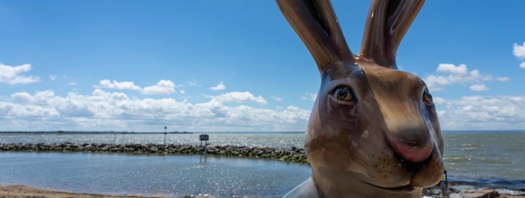 close up of Hare sculpture with the sea in the background