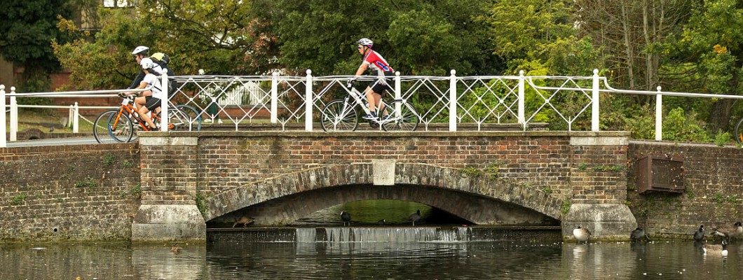 cyclists riding over a bridge