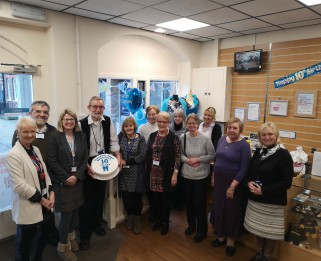 Staff and volunteers at the Rochford Shop with a birthday cake