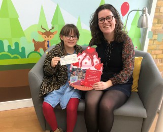 Alice presenting the cheque at Little Havens