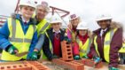 School children in hard hats visit the new hospice building site