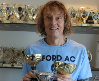 Terry holding his trophies from Southend Half