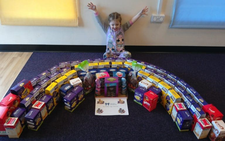 A child at the Nursery presents the Easter Egg collection
