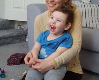 Jimmy and his mum taking part in online music therapy