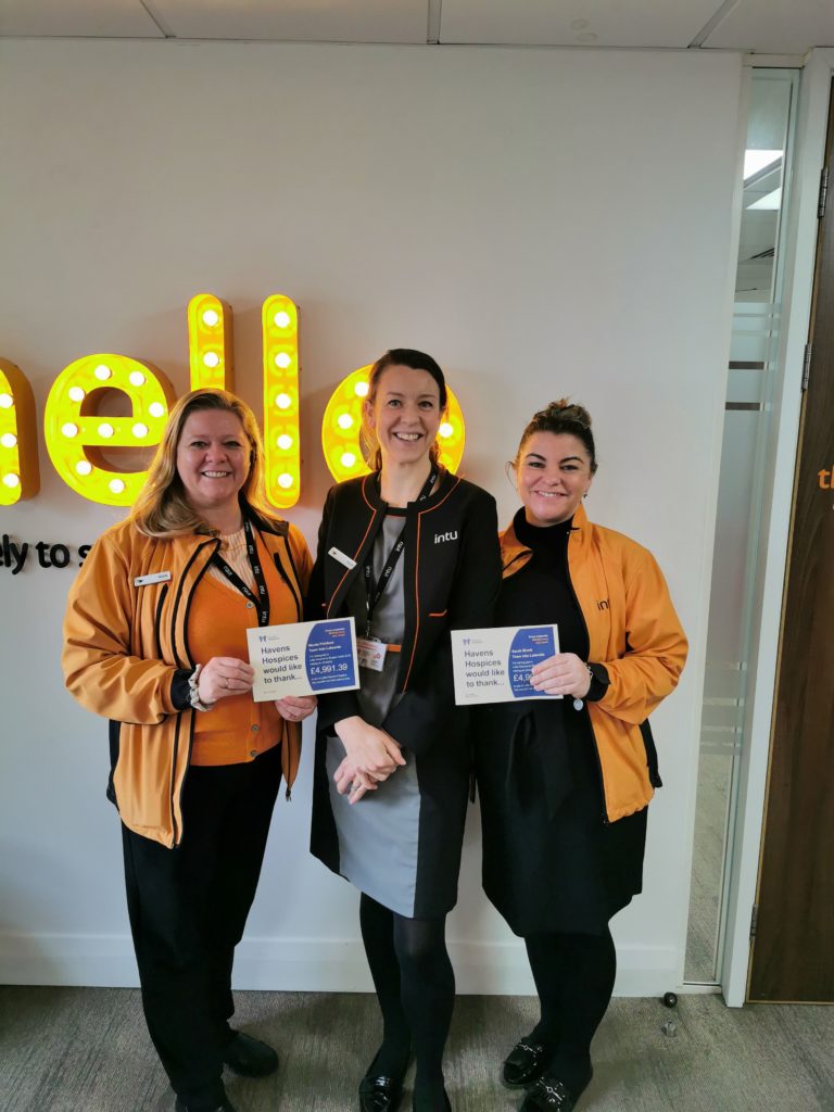 Members of staff from intu Lakeside with their cheque for £4,991 which they raised through their cycle challenge back in 2019