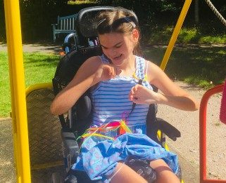 Ava on the wheelchair swing at Little Havens