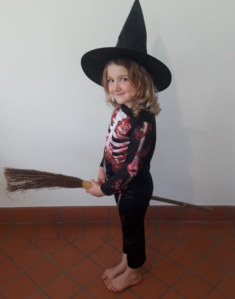 Girl dressed up as a witch for the Halloween Trail