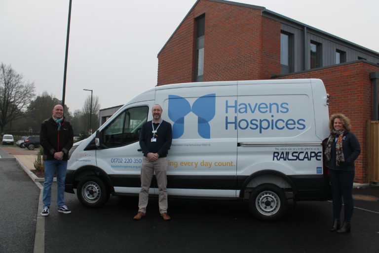 Michael Hayes and Sam Clement from Railscape with Steve McClure from Havens Hospices with the new van outside Fair Havens Hospice
