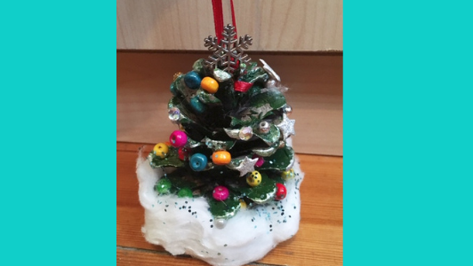 pine cone painted green and decorated to look like christmas tree