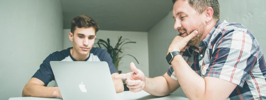 two people looking at computer screen