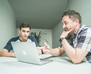 two people looking at computer screen