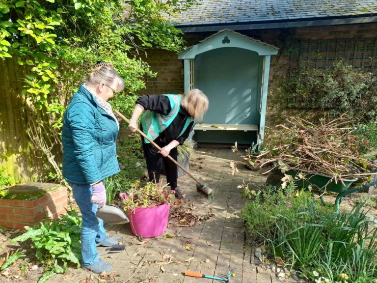 Two volunteers gardening at Little Havens