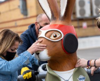 Hare sculpture looks like a pilot being wheeled across the car park