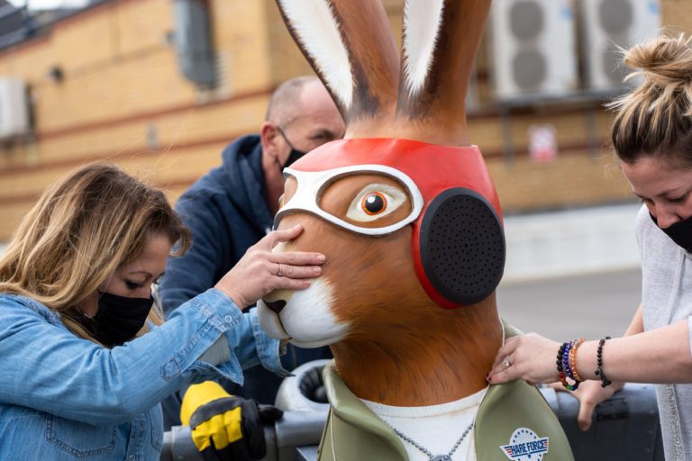 Hare sculpture looks like a pilot being wheeled across the car park