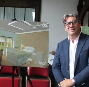 Paul stood next to an artistic impression of the new hospice