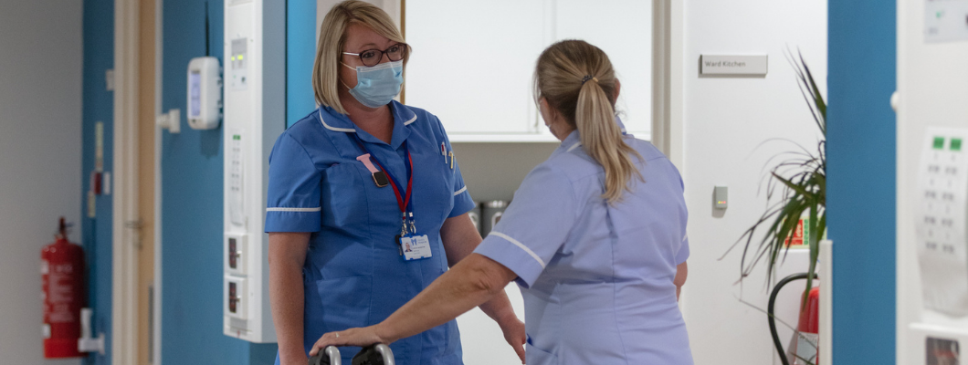 two nurses talking in the corridor at Fair Havens