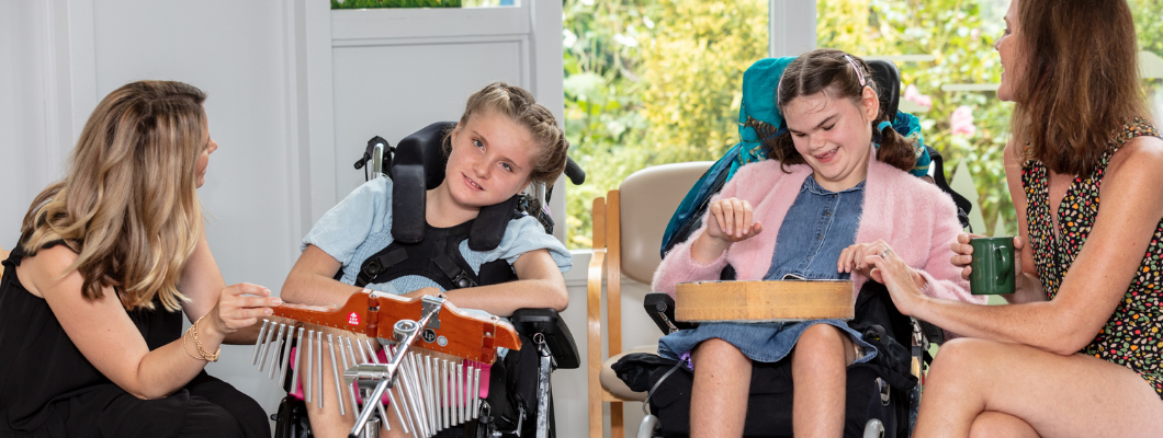 Ava and Evie enjoying music therapy at the hospice with family