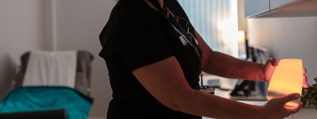 Complementary therapist adjusting calming light on side