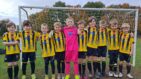 Broomfield Tigers U9s Team Supporting Little Havens - the team standing in front of a goal on a football pitch