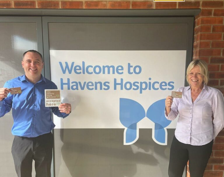 Lee Hodgins And Jackie May, Area Managers For Havens Hospices Shops standing outside Fair Havens Hospices with Charity Shop Gift Card