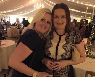 Amanda and her sister Gemma hugging at a party