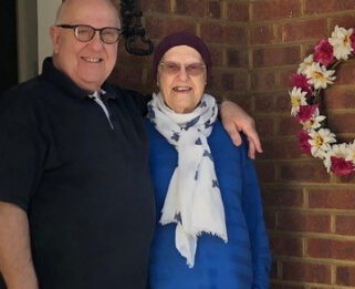 Chrissie and her husband David stood outside home