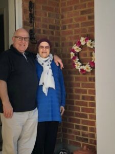 Chrissie and her husband David stood outside home