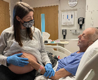 Fred with his daughter in law at Fair Havens feeling baby move in her belly