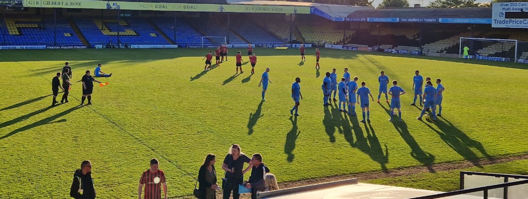 Football players running across a football pitch