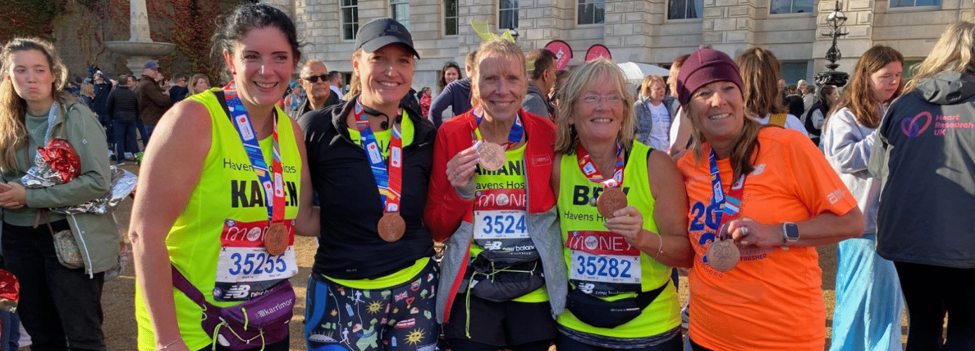 Group of team havens runners from 2021 wearing medals at end of race