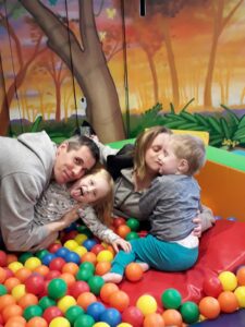 Noah, with mum dad and sister in ball pit