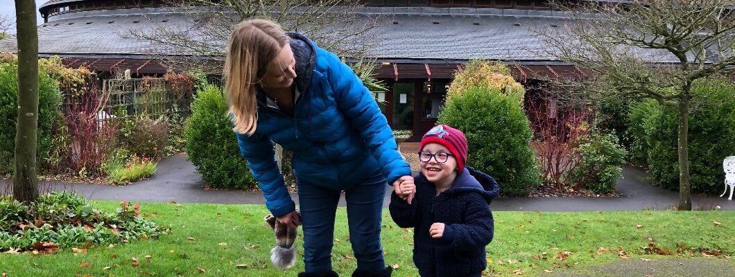 Noah, laughing with his Mum in the Little Havens gardens