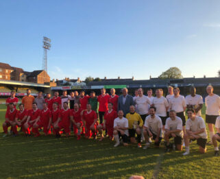 Group of people with football kits on a football pitch