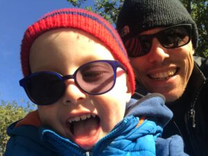 Noah in sunglasses taking selfie with dad