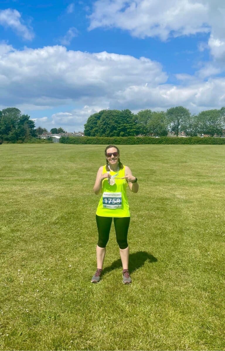 Melissa holding her medal after the Southend Half Marathon