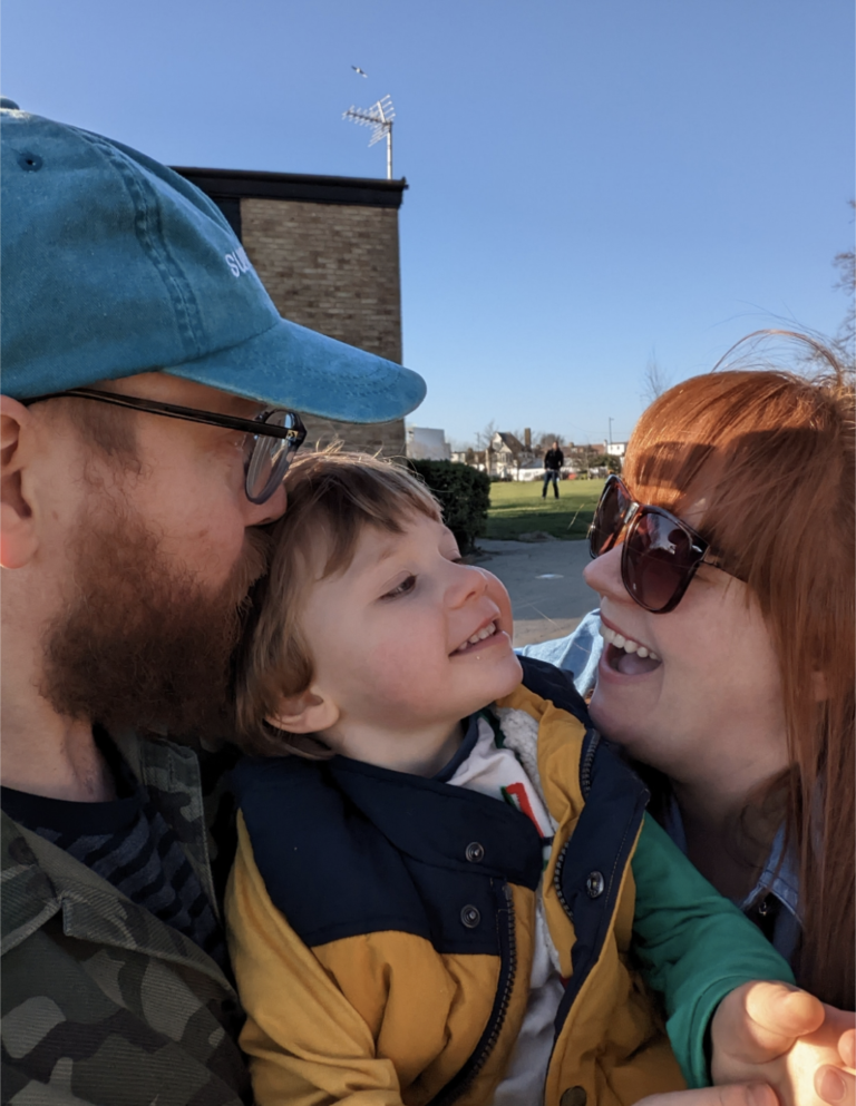 Adam, Arizona and Deborah smiling together for a photo