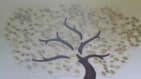 The leaves of life tree display on a large white wall
