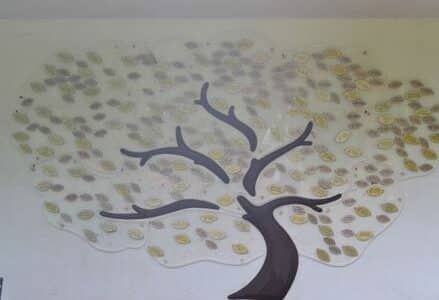 The leaves of life tree display on a large white wall