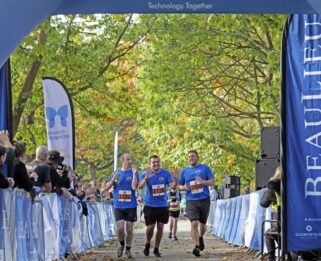 Three runners at the finish line of Chelmsford Marathon