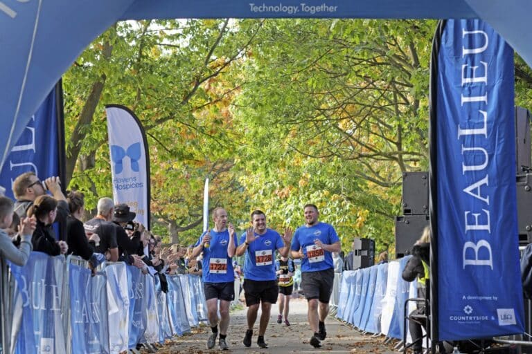 Three runners at the finish line of Chelmsford Marathon