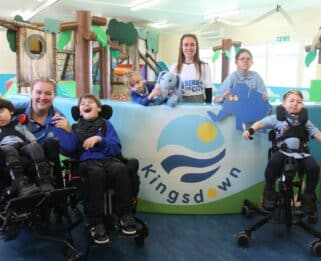 Kingsdown School pupils in front of school logo with a knitted and cut out elephant