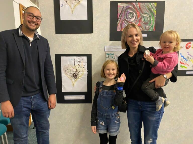 Aron, Dottie, Jen and Norah standing in front of artwork