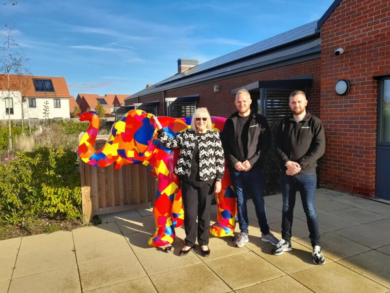 Cllr Carole Mulroney, Liam Cousins, Tom Duke standing in front of patchwork elephant