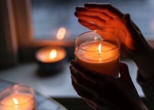 Hand holding a candle