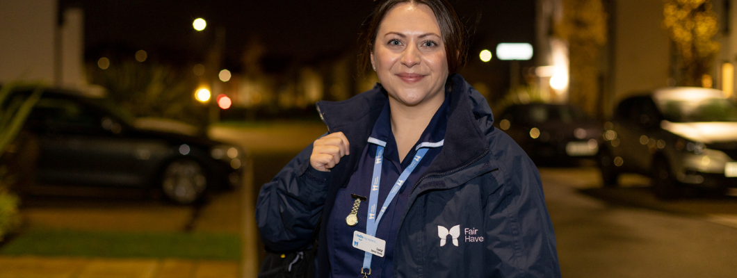 Hospice at Home nursing wearing branded Havens coat stood outside, in the background you can see a road with cars