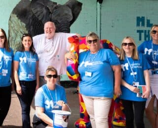 Havens Hospices employees with artist John Bulley standing with Duke the patchwork elephant